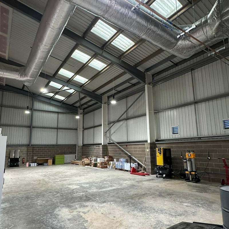 A large warehouse in Leeds with wires and ventilation ducts.
