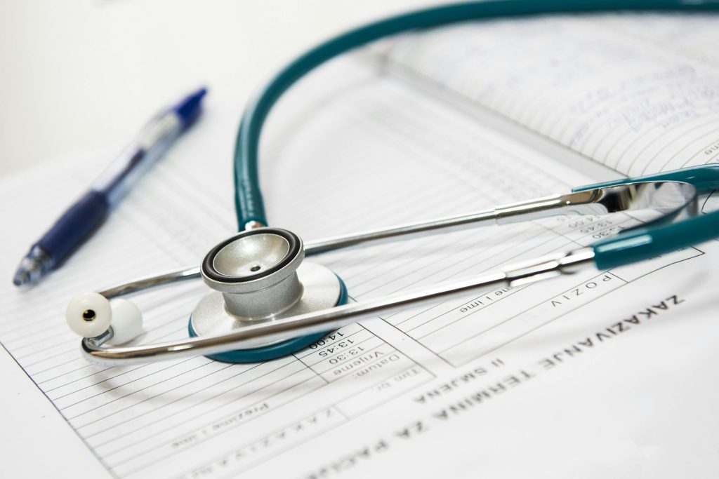 picture of a stethescope and pen to represent the need for electrical contractors in the healthcare industry